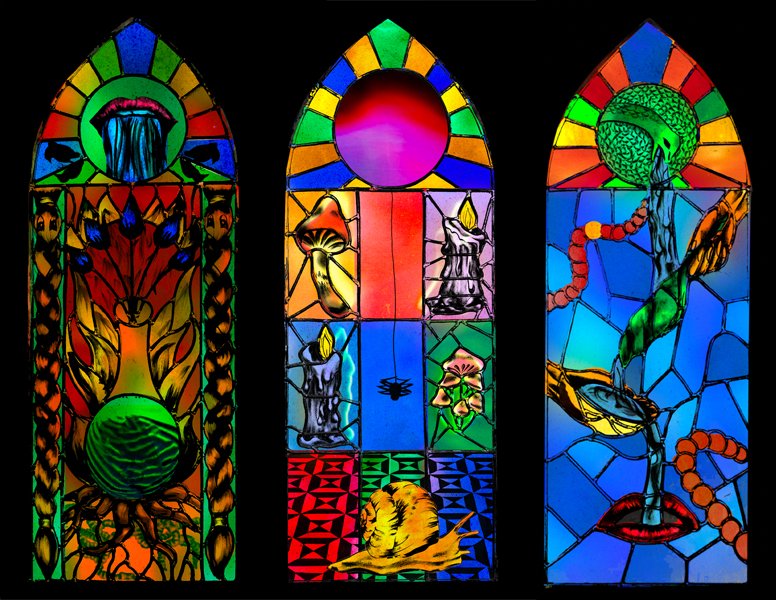 Three stained-glass windows displaying a variety of trees, animals, and magical imagery