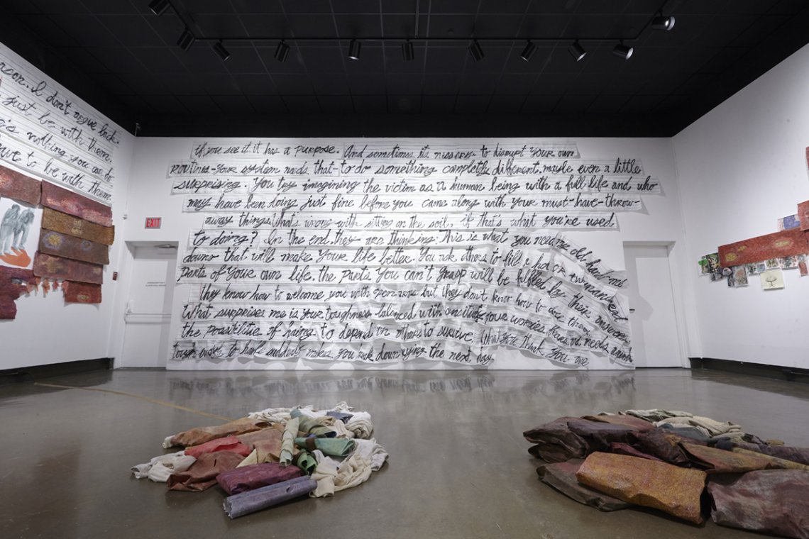 image of gallery exhibition with walls covered in writing