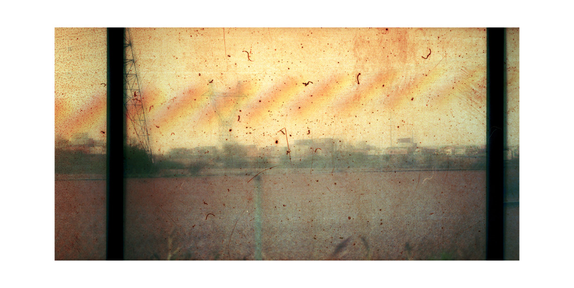 Scratchy, yellowingilm still of a the frames of a film reel against a dusty backdrop in Salvage Archives by Miles Rufelds