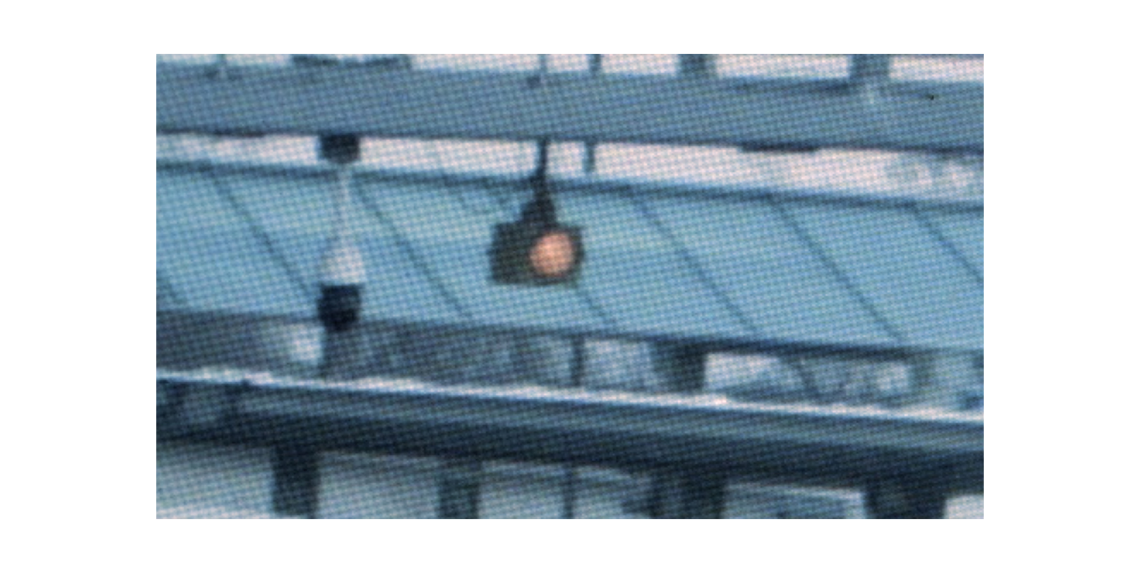 Traffic light turned red hanging from a pole