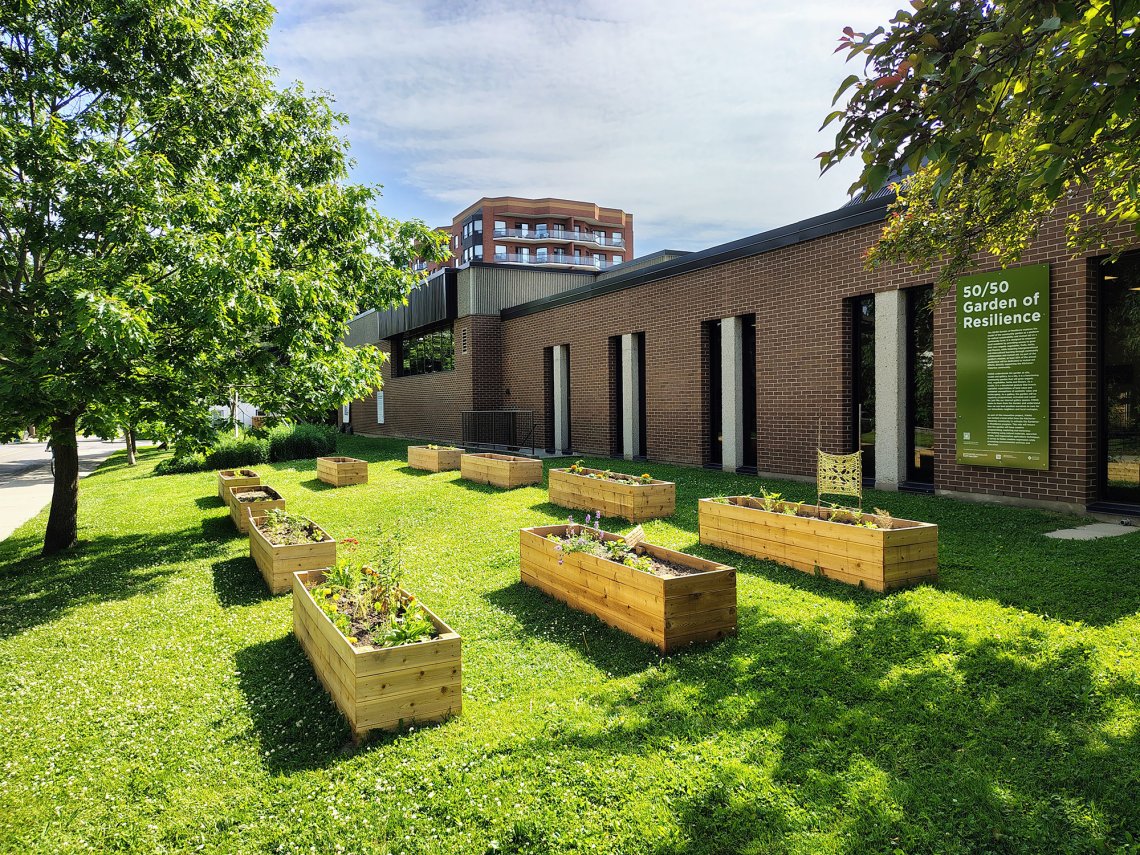 Overhead photo of the verdant Garden of Resilience situated beside the KWAG red brick building