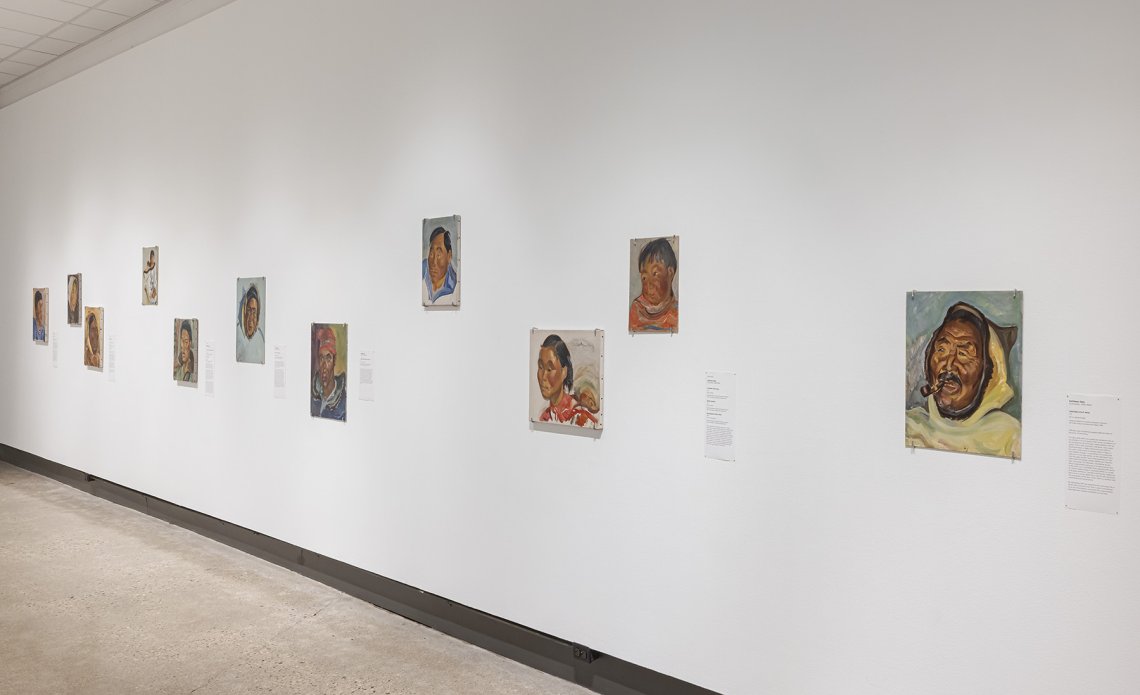 Side view of over ten painted portraits of people from of northern Québec and Labrador communities 