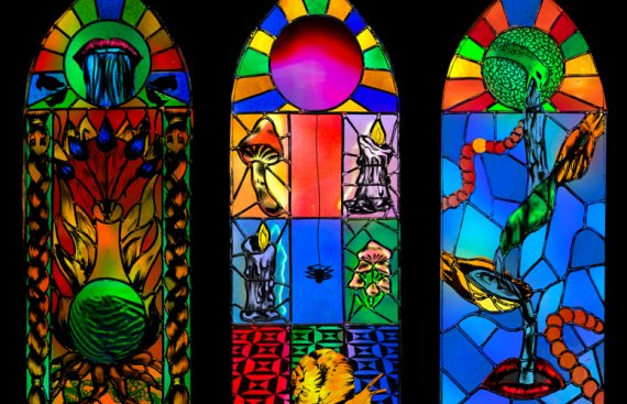 Three stained-glass windows displaying a variety of trees, animals, and magical imagery