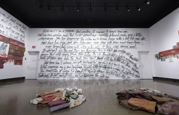 image of gallery exhibition with walls covered in writing