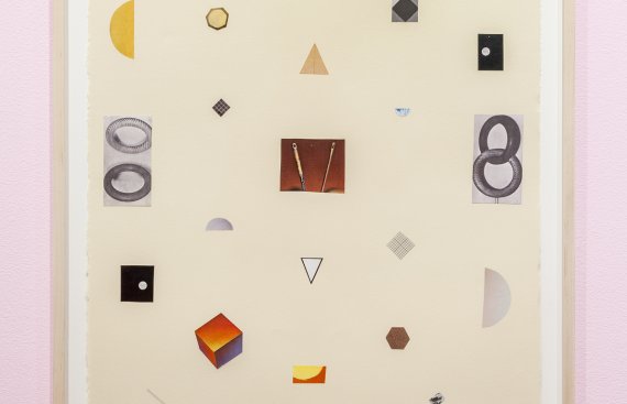 image hung on a pink wall with random shapes and pieces put onto a white backdrop to make a design