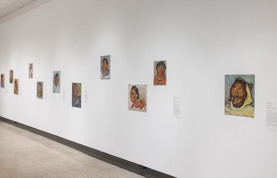 Side view of over ten painted portraits of people from of northern Québec and Labrador communities 