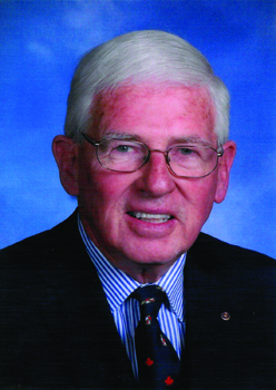 Photo of Ivan Hurlbut, an older man with white hair and glasses against a blue photography studio backdrop
